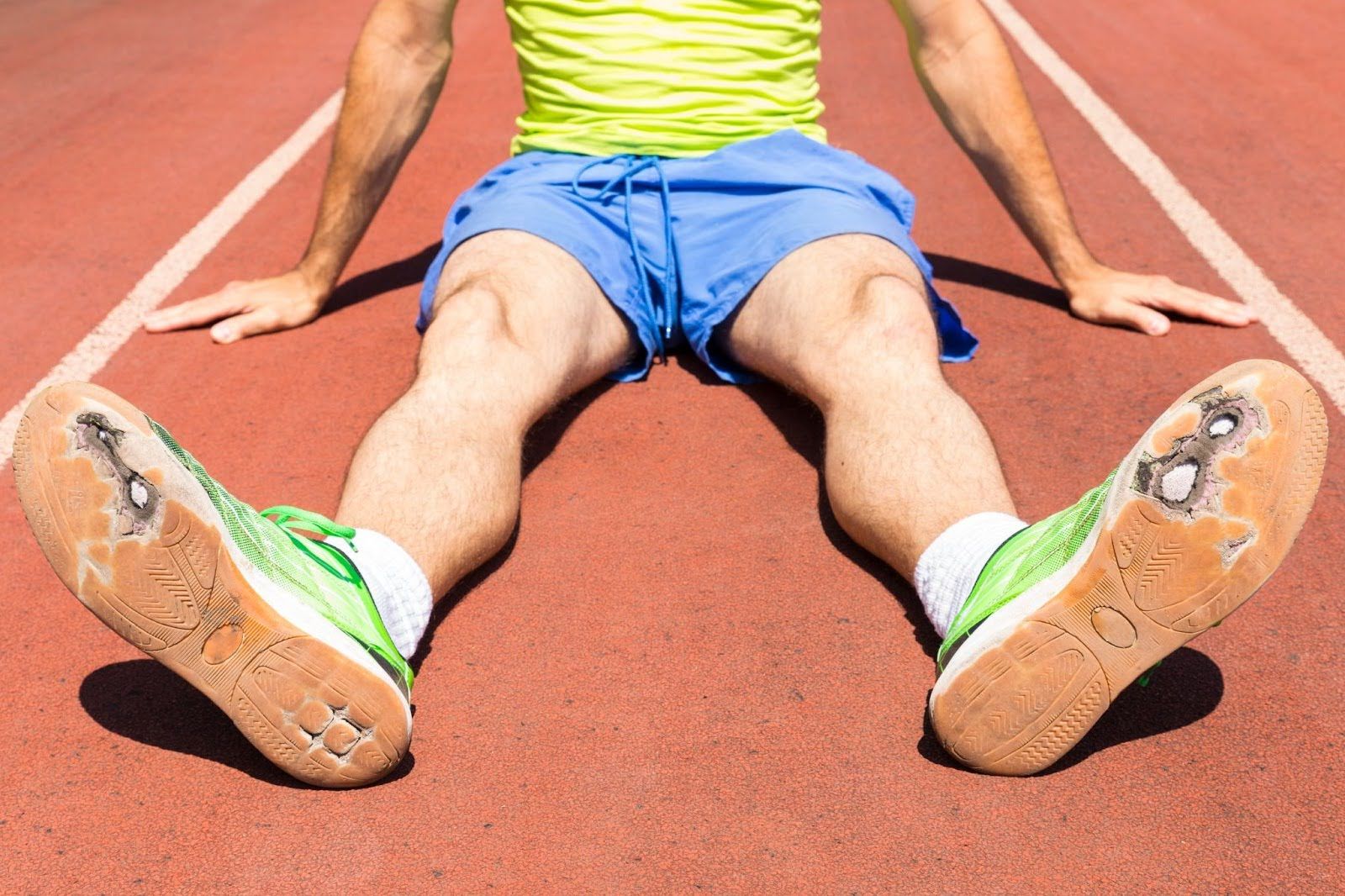 Athlete wearing worn-out running shoes ready to be replaced