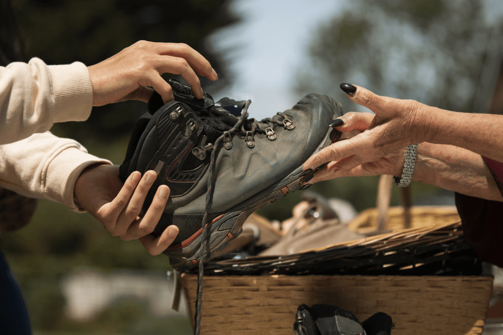 Man donating old shoes